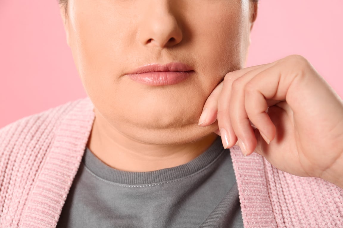 Woman with Double Chin on Pink Background, Closeup